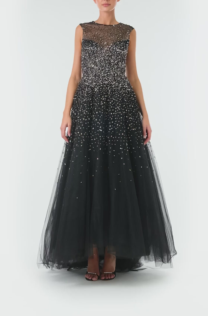Monique Lhuillier Spring 2024 black tulle gown with metallic embroidery and high-low hem - video.