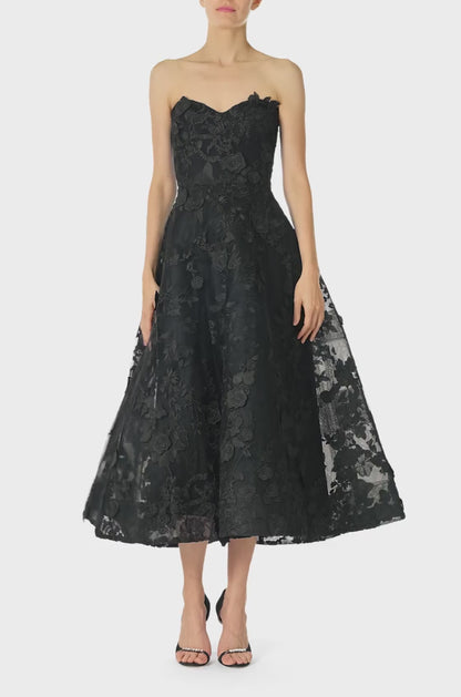 Monique Lhuillier Fall 2024 tea-length, strapless dress in noir 3D lace with full skirt and fitted sweetheart bodice - video.