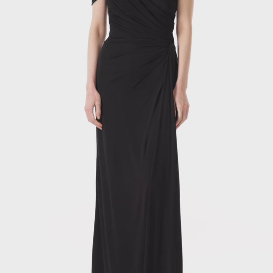 Monique Lhuillier asymmetric neckline gown in black jersey and velvet with draped bodice and front slit.