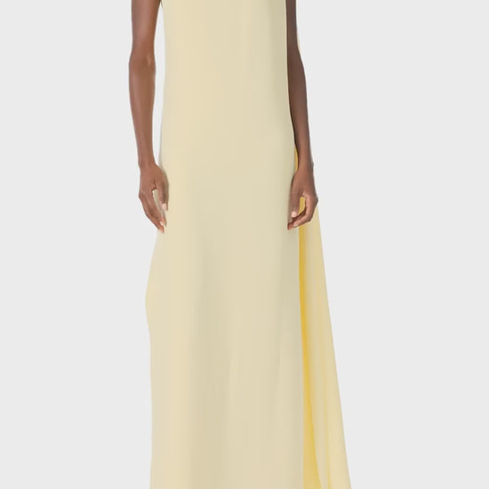 Monique Lhuillier Spring 2025 draped shoulder caftan gown with integral cape and side slit in limoncello yellow - video.