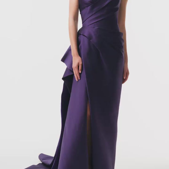 Monique Lhuillier Fall 2025 floor length gown with draped bodice and front leg slit in violet mikado fabric - video.