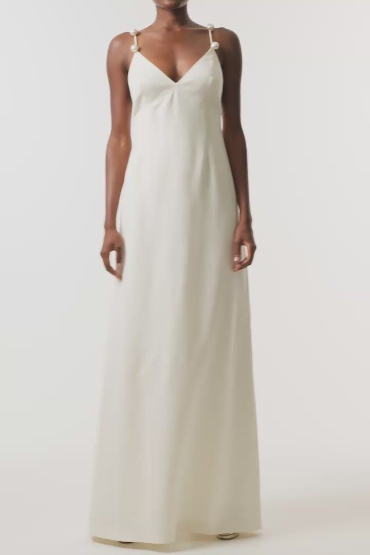 Monique Lhuillier Spring 2026 Ivory Lightweight Silk Wool Suiting A - line V -neck gown with pearl ball straps - video.