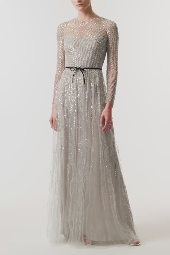 Monique Lhuillier Fall 2026 silver, long sleeve embroidered tulle gown with black velvet belt at waist - video.