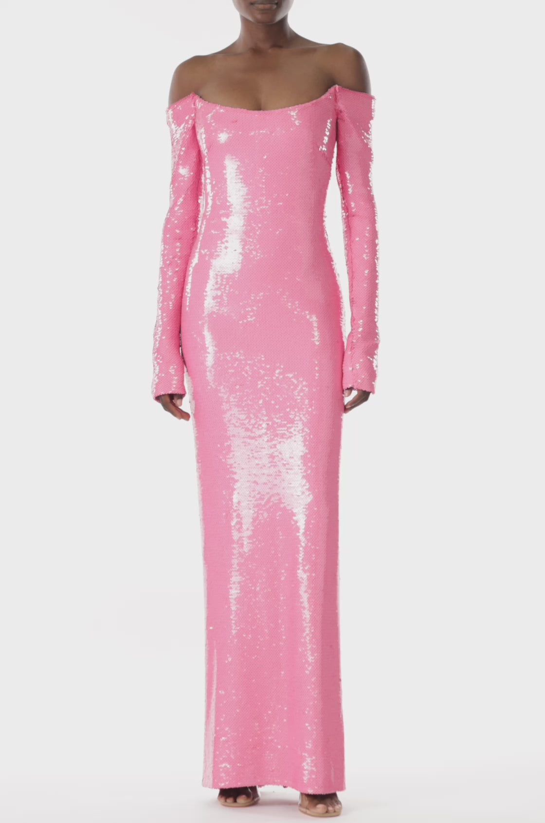 Monique Lhuillier pink sequin column gown with long sleeves and a scoop neckline.