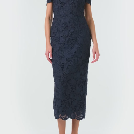 Monique Lhuillier Fall 2024 night sky colored lace sheath dress with short sleeves, scoop neckline and lace scalloped detailing - video.