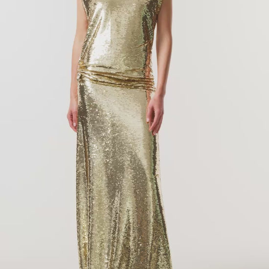 Monique Lhuillier Fall 2026 Gold Sequin to piece Sleeveless top with floral embellishment and evening skirt - video.