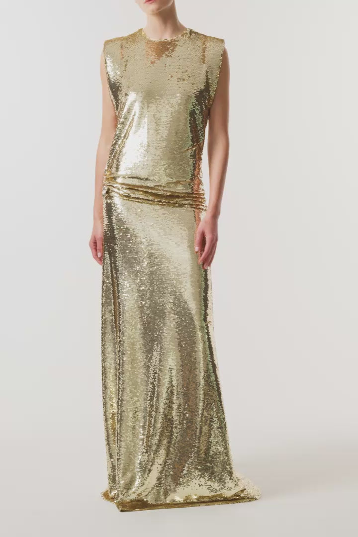 Monique Lhuillier Fall 2026 Gold Sequin to piece Sleeveless top with floral embellishment and evening skirt - video.