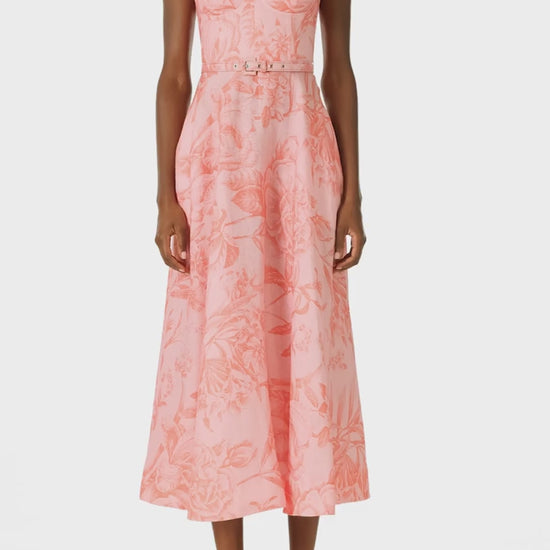 Monique Lhuillier Spring 2025 Floral printed a-line midi dress with spaghetti straps, corseted bodice and pockets in Rosette Coral colored linen - video.