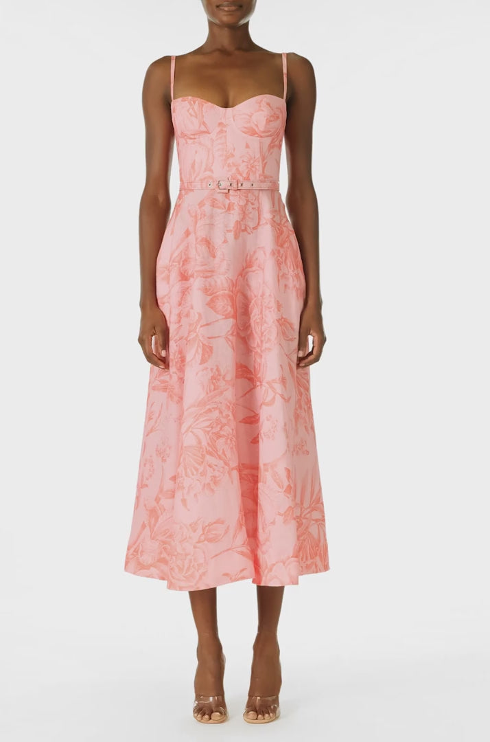 Monique Lhuillier Spring 2025 Floral printed a-line midi dress with spaghetti straps, corseted bodice and pockets in Rosette Coral colored linen - video.