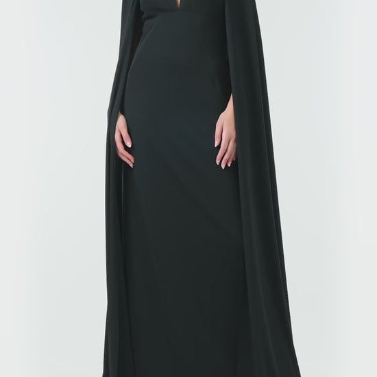 Monique Lhuillier Spring 2024 black crepe-back satin gown with attached cape and keyhole bodice - video.