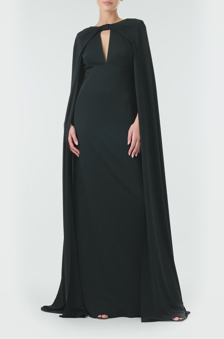 Monique Lhuillier Spring 2024 black crepe-back satin gown with attached cape and keyhole bodice - video.