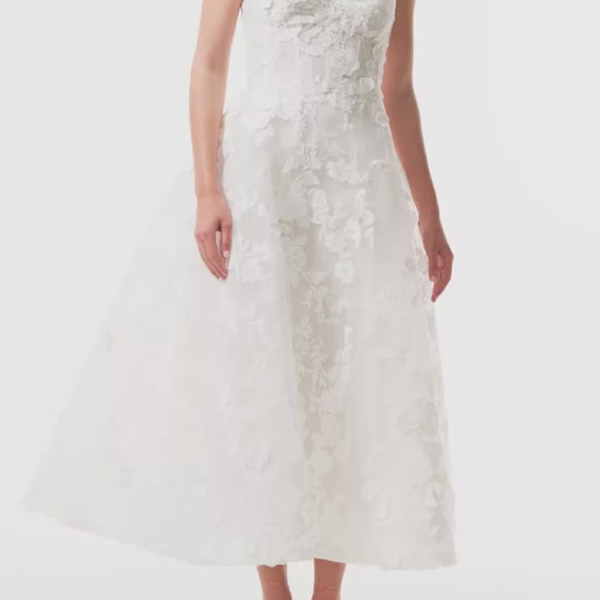 Monique Lhuillier Fall 2024 tea-length, strapless dress in silk white3D lace with full skirt and fitted sweetheart bodice - video.