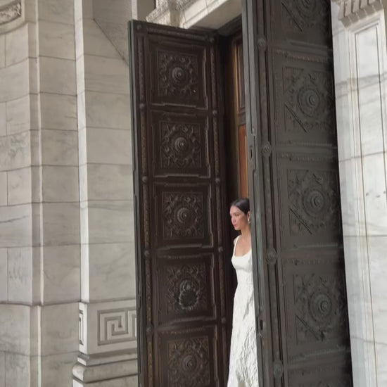 Monique Lhuillier Fall 2025 scoop neck, a-line dress in ivory floral jacquard fabric - Instagram video.
