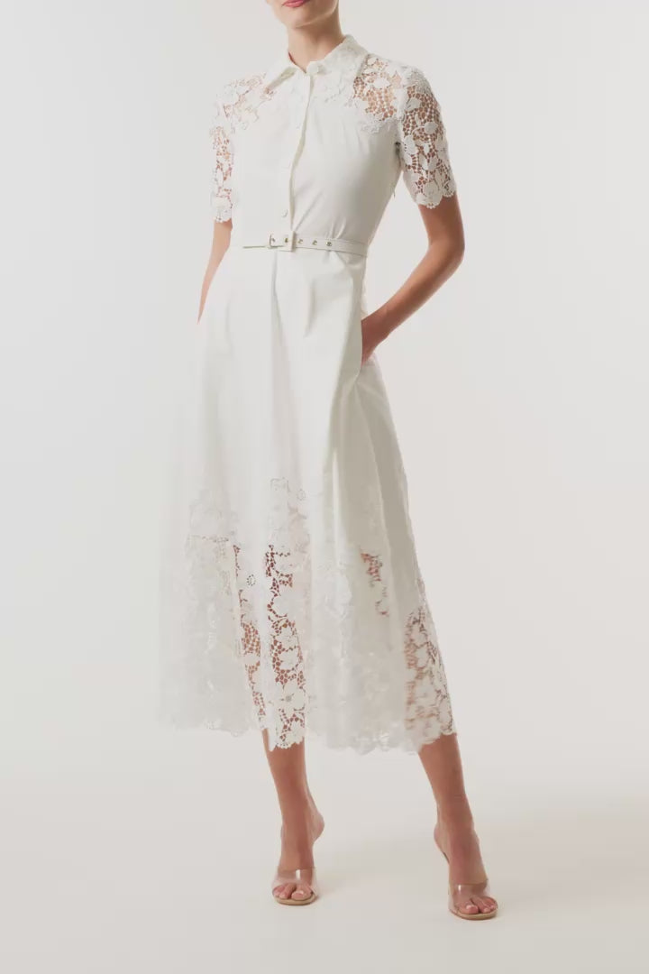 Monique Lhuillier Spring 2025 white cotton poplin dress with lace applique inserts, short sleeves, button down front bodice and belted waist - video.