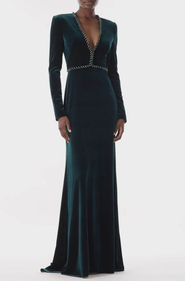 Monique Lhuillier long sleeve gown with deep v-neck and embroidery trim in dark teal velour.