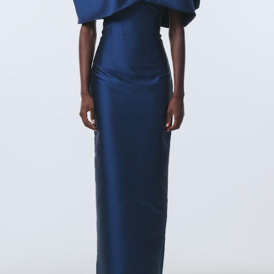 Monique Lhuillier Spring 2026 Navy Mikado Asymmetric drape neckline column gown - video.
