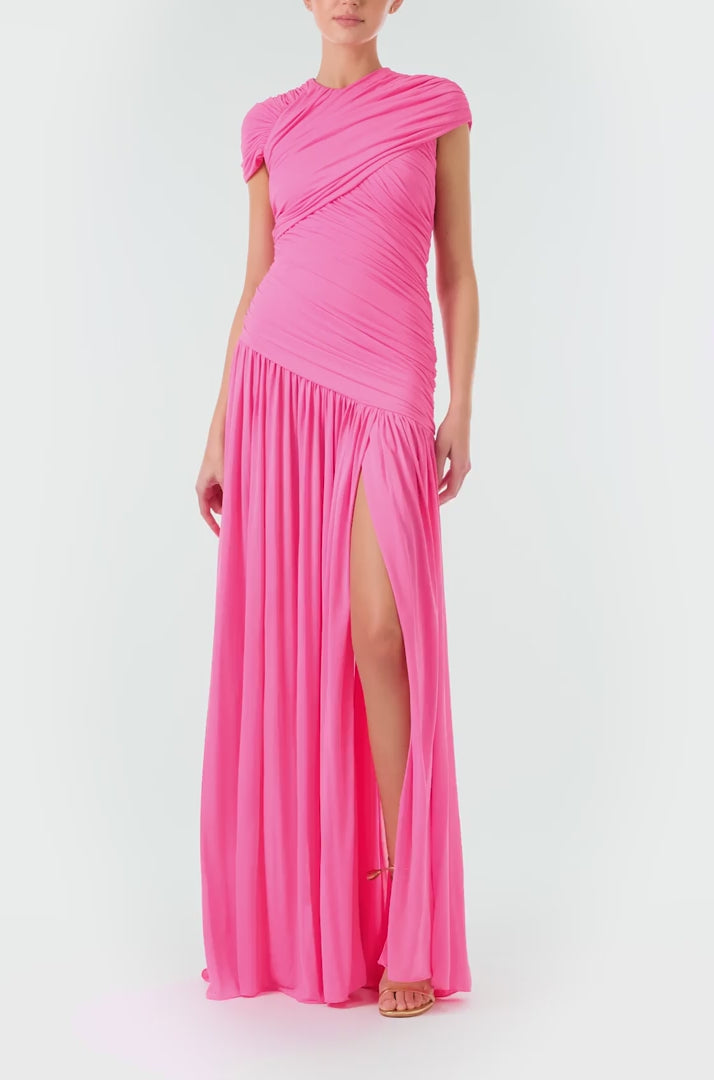 Monique Lhuillier Fall 2024 draped, asymmetric gown with drop waist, cap sleeves and front leg slit in pink crepe jersey fabric - video.