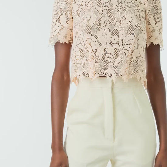 Monique Lhuillier Spring 2024 blush lace short sleeve, jewel neck lace top with sculpted shoulder and lace scallop detailing - video.