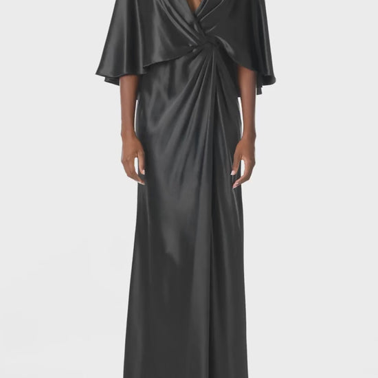 Monique Lhuillier deep V-Neck draped gown with attached capelet and high leg slit in black crepe back satin - video.