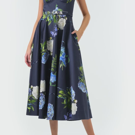 Monique Lhuillier Fall 2024 blue floral spaghetti strap, a-line midi dress with corseted bodice, pockets and belted waist - video.