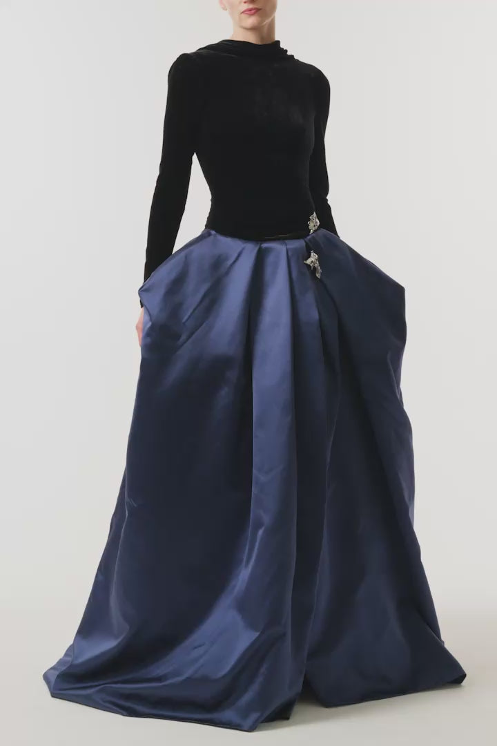 Monique Lhuillier Fall 2026 Noir and Navy Velvet and Duchess Satin long sleeve high neck pleated ballgown with silver floral embellishment - video. 