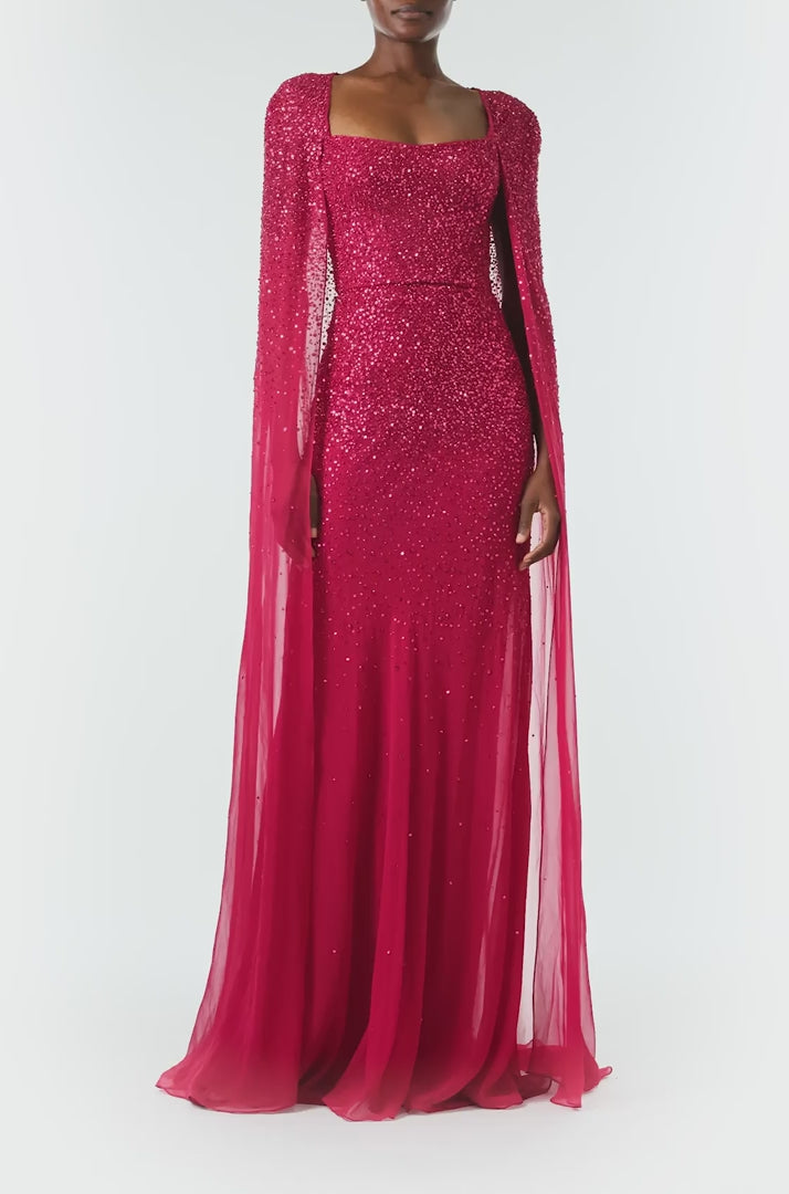 Monique Lhuillier Fall 2024 Scoop neck, floor length gown with integral cape in Merlot embroidered chiffon - video.