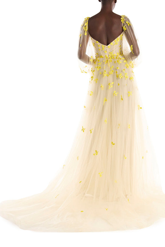 Cameo colored tulle gown with yellow embroidery over illusion long sleeves and sweetheart neckline.