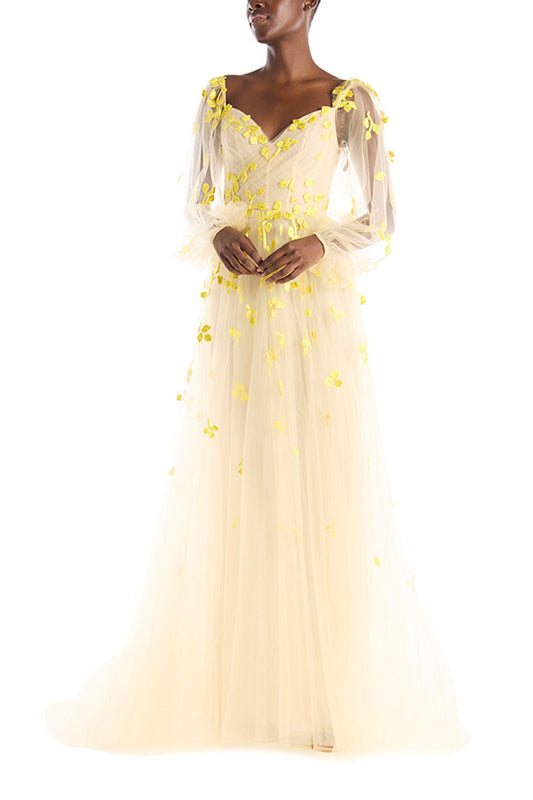 Cameo colored tulle gown with yellow embroidery over illusion long sleeves and sweetheart neckline.